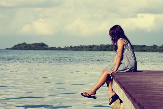 Girl reflecting on the dock