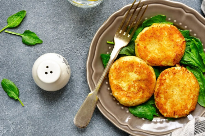 These easy-to-make Crispy Cheesy Cauliflower Fritters are reminiscent of traditional potato latkas, minus the belly-bloating carbs. Get the recipe!