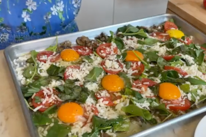 sunny-side-up eggs in a sheet pan over vegetables