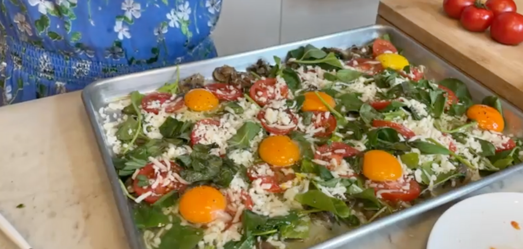 sunny-side-up eggs in a sheet pan over vegetables