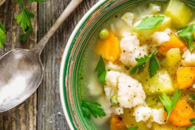 chicken soup served in a bowl bringing comfort and health.