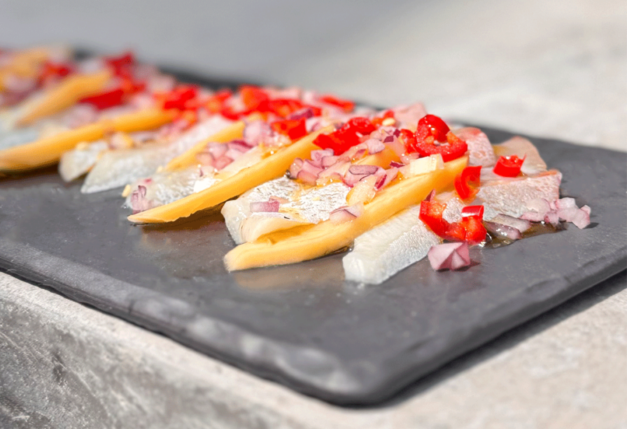 Yellowtail Sashimi Platter with Mango and Chili on a slate serving platter