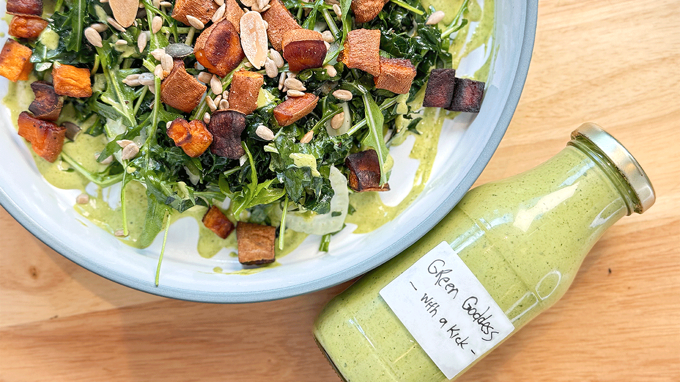Kale Salad with Crispy Sweet Potato Croutons, arugula, fennel, and Green Goddess dressing, garnished with seeds and lime