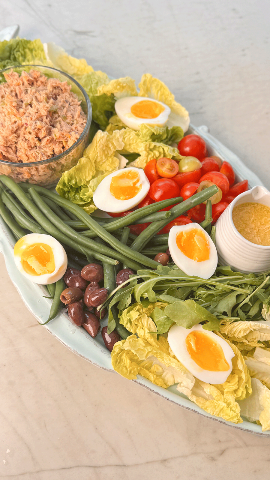 Tuna Niçoise Brunch Platter with soft-boiled eggs, green beans, lettuce, tomatoes, and herby tuna salad